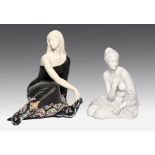 A Nadal figure of a seated young woman in a black and polychrome dress, 28cm h, printed mark and a