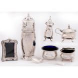 A George V silver sugar caster and cover, 15cm h, marks rubbed, loaded, a silver salt cellar,