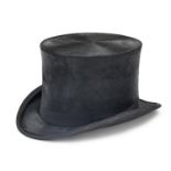 A top hat, early 20th c, aperture 17.5 x 20.5cm, in velvet lined leather hat bucket with a number of