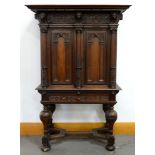 A Dutch architectural oak and ebony cabinet on stand, late 17th c, the carved frieze of shells and