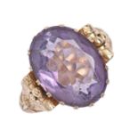 A Continental amethyst ring, in gold, with chased hoop and leaf shoulders, indistinct maker's