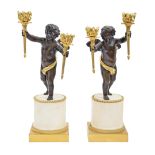 A pair of French bronze and ormolu Putto figural candelabra, late 19th c, after  of Claude Michel,