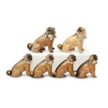 Eight German porcelain models of pug dogs, late 19th c, in a blue or green ribbon collar with bells,