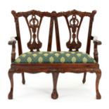 Miniature furniture. A carved and mahogany-stained twin chair back settee, in George II style,