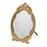 A French ormolu easel mirror, c1900, in Louis XVI style, crested by a musical trophy, brass strut,