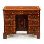 A Victorian inlaid mahogany kneehole dressing table, crossbanded in satinwood with fan spandrels and