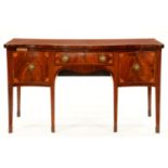 A George III   serpentine  mahogany and line inlaid sideboard, the front crossbanded and inlaid at