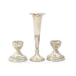 A pair of Elizabeth II dwarf silver candlesticks, 58mm, maker B & Co, Birmingham 1975, loaded and