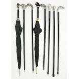 Eight decorative reproduction canes and umbrellas, with silvered resin or other handle  One damaged