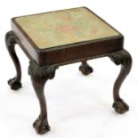 A carved mahogany stool, c1900, on cabriole legs, adapted as a table with glass top, 44cm h; 50 x