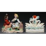 A German porcelain group of a seated youth and girl with animals and a birdcage, late 20th c, 13cm h