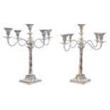 A pair of EPNS candelabra, of five lights and reeded scrolling branches, the candlesticks stamped