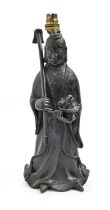 A Chinese bronze sculpture of a female immortal, late 19th/early 20th c,  holding a flower in a