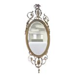 A Victorian oval giltwood and composition mirror, in Neo Classical style, the bevelled plate in