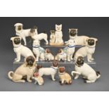 Fifteen German porcelain and biscuit models of pug dogs, late 19th c, including several pairs,