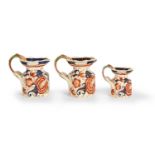 One and a pair of Japan pattern Ironstone hydra handled jugs, mid 19th c, 12 and 16cm h, impressed