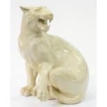 A white glazed earthenware model of a tigress, late 20th c, 73cm h Good condition