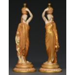 A pair of Royal Worcester figures of Grecian water carriers, 1913, with contemporary brass fitment