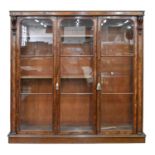 A Victorian mahogany bookcase, fitted with adjustable shelves enclosed by three low arched, glazed