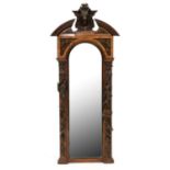 A German walnut and carved and stained wood mirror, late 19th c, the open segmental pediment centred