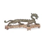A Chinese bronze sculpture of a dragon, uneven worn green patina, 30cm l, wood stand Good condition