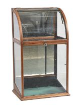 A glazed mahogany cylinder front taxidermy or other case, early 20th c, with mirror back, 108cm h;