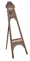 A North Indian carved and pierced wood easel, c1900, 179cm h Small losses and repairs