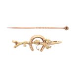 A gold horseshoe twig brooch, early 20th c, 46mm l, marked 15ct, 2.3g and a gold stickpin, lacks