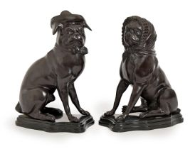 A pair of bronzed metal models of seated pug dogs in hat or bonnet, on stepped black marble resin