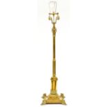 An Edwardian telescopic brass columnar oil lamp, on square base and four demi-lion feet, adapted for