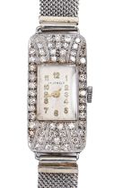 A diamond cocktail watch, c1940, millegrain set in platinum, 13 x 26mm, on white gold mesh bracelet,