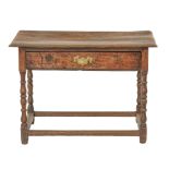 A William III joined oak side table, the oversailing top with moulded lip above full width drawer