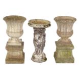 A pair of reconstituted stone garden vases and a bird bath, the vases of waisted spool shape