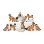 Ten German porcelain models of pug dogs, including a condiment set and two fairings, one in the form