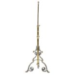 An Edwardian telescopic brass and burnished steel oil lamp, the volute tripod applied with shells