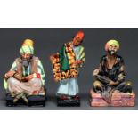 Three Royal Doulton earthenware orientalist figures, circa second quarter 20th c, comprising