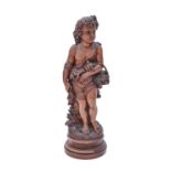 A boxwood statuette of a child with a bird's nest, 19th / 20th c, on turned socle, 35cm h Two of the