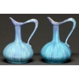 A pair of art pottery ewers, c1910, in streaked lavender blue and turquoise glaze, 20cm h Undamaged,