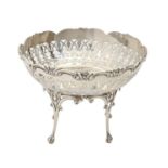 A George V pierced silver sweetmeat bowl, on four pierced legs with claw and ball feet, 12cm h, by