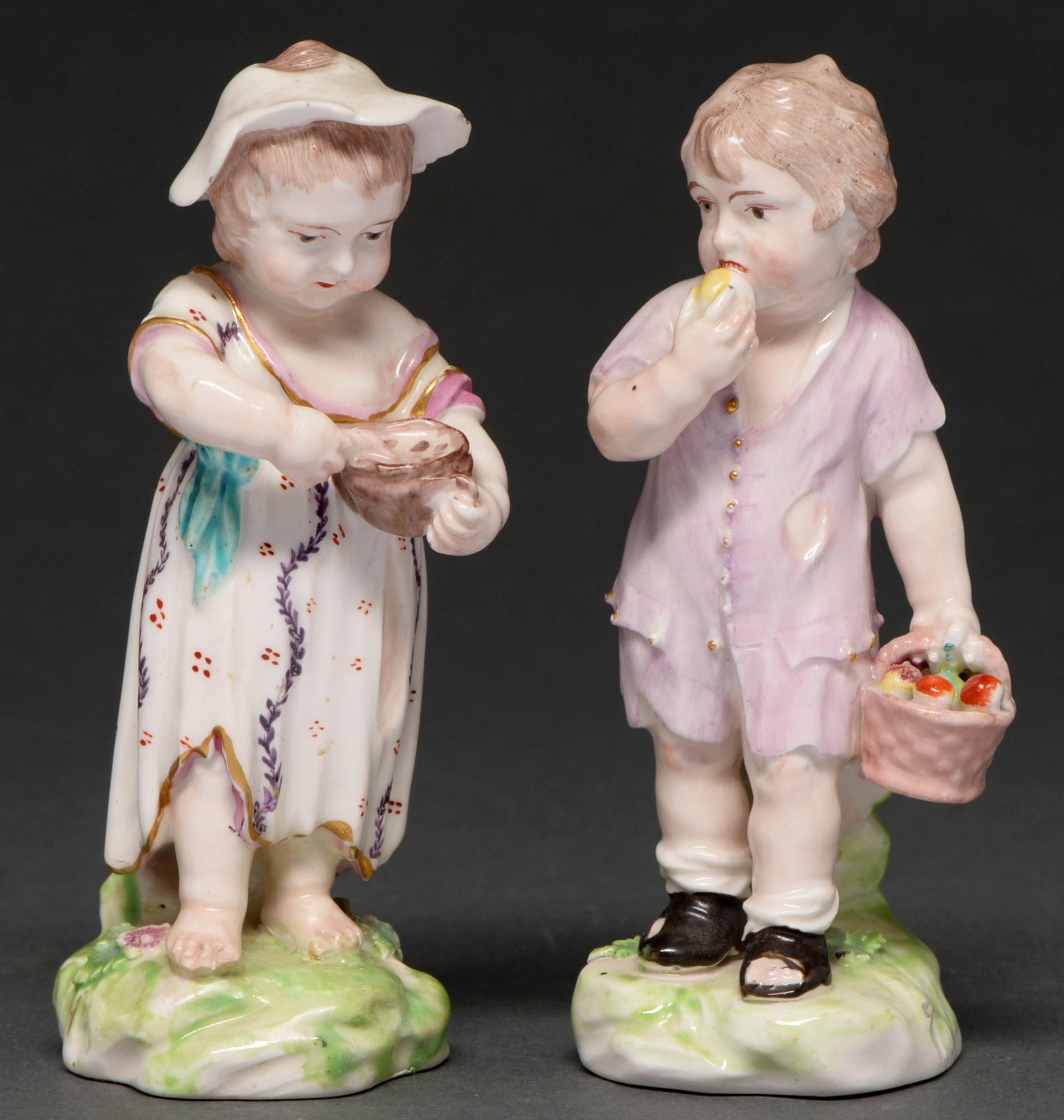 A pair of Derby figures of a ‘grotesque boy and girl’ or ‘boy eating an apple and curds-and-whey’,