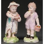 A pair of Derby figures of a ‘grotesque boy and girl’ or ‘boy eating an apple and curds-and-whey’,