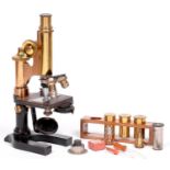 A brass compound microscope, E Leitz Wetzlar, No 109604, 1908, with two eyepieces, five objective