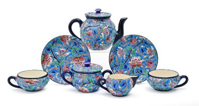 A Longwy tea service, early 20th c, with brightly coloured 'cloisonne' flowers and foliage on a