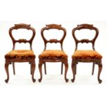 A set of three Victorian mahogany dining chairs, the scrolling legs with carved volute feet Sound,