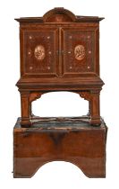 A Spanish tooled leather writing cabinet, c1920, with breakarched pediment and fitted interior