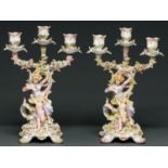 A pair of German  floral encrusted candelabra, late 19th c, of three lights, the base with the