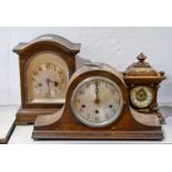 An oak Napoleon mantel clock, c. 1930, silvered dial with Arabic numerals, 42cm w, another two