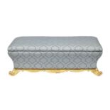 A Victorian blue brocade covered giltwood and composition ottoman, with padded lid and flared sides,