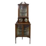 An Edwardian mahogany standing corner cabinet, crossbanded in satinwood, with fret pattern glazing
