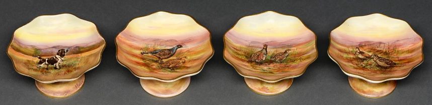 A set of four Royal Winton stands, 1930s, printed and painted with gamebirds or dog, 13cm diam,